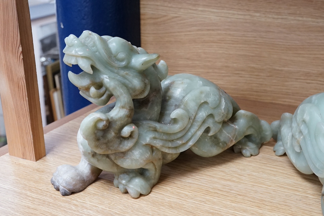 A pair of carved Chinese bowenite jade dragons, 28cm wide. Condition - fair